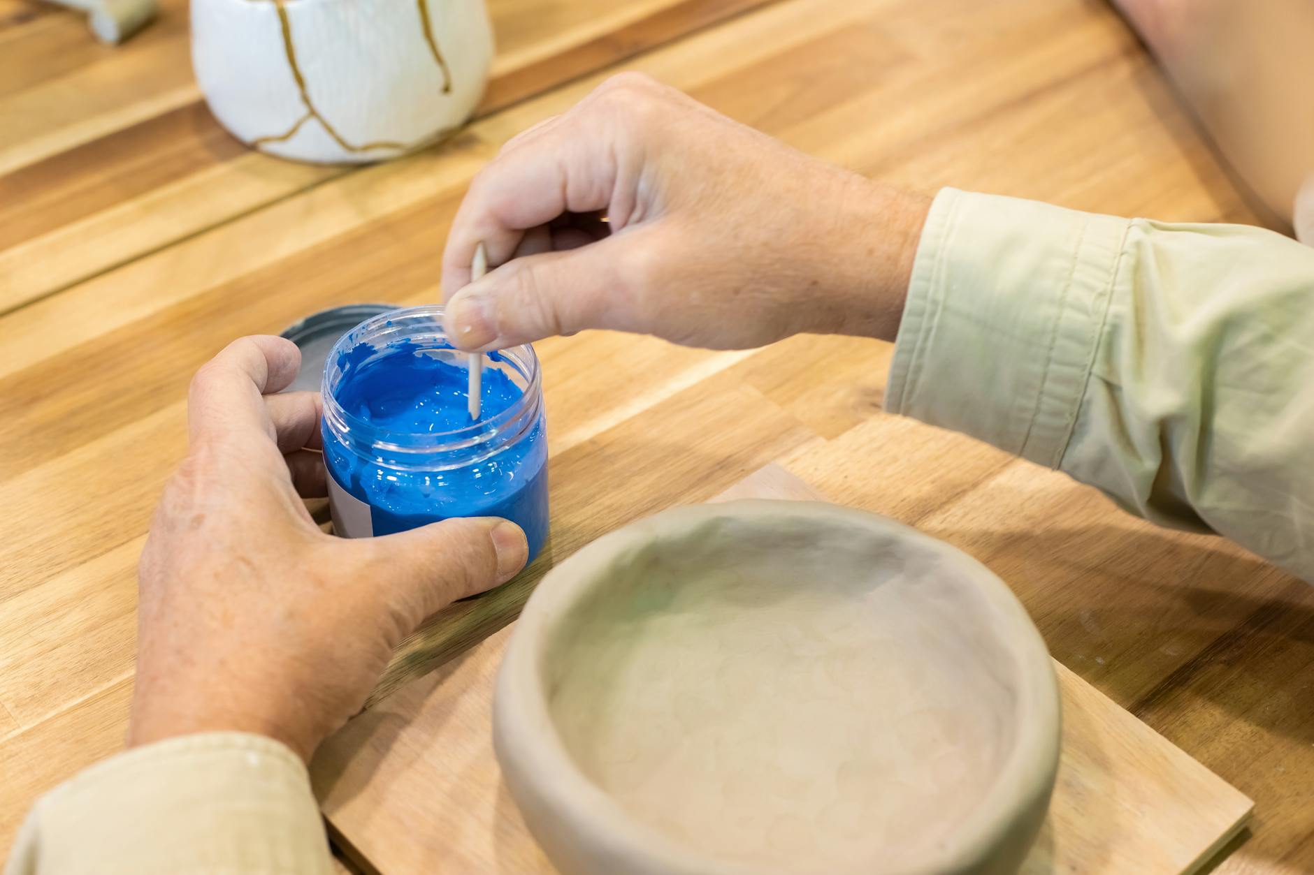 GLAZE meaning coating applied before firing to add color and finish