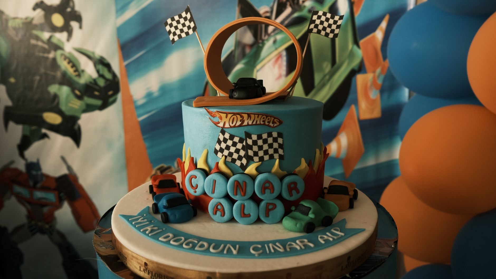 HOT WHEELS — the meaning is a toy car brand known for fast-themed die-cast cars